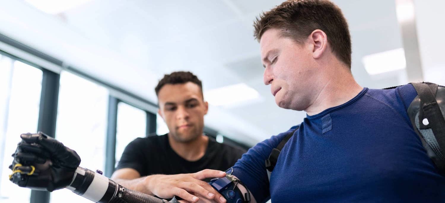 Post-amputation patient manages their limb loss pain and tries on a prosthetic limb