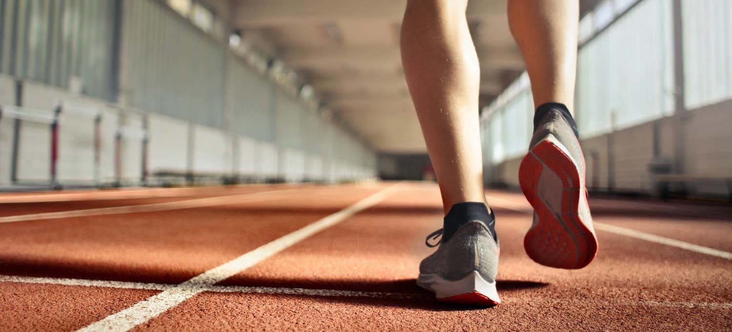 A person walking on a track with good shoes for exercise