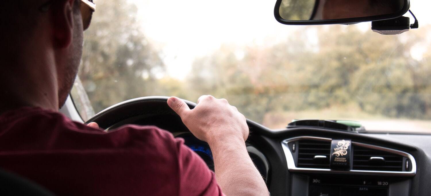 Person driving from the back angle