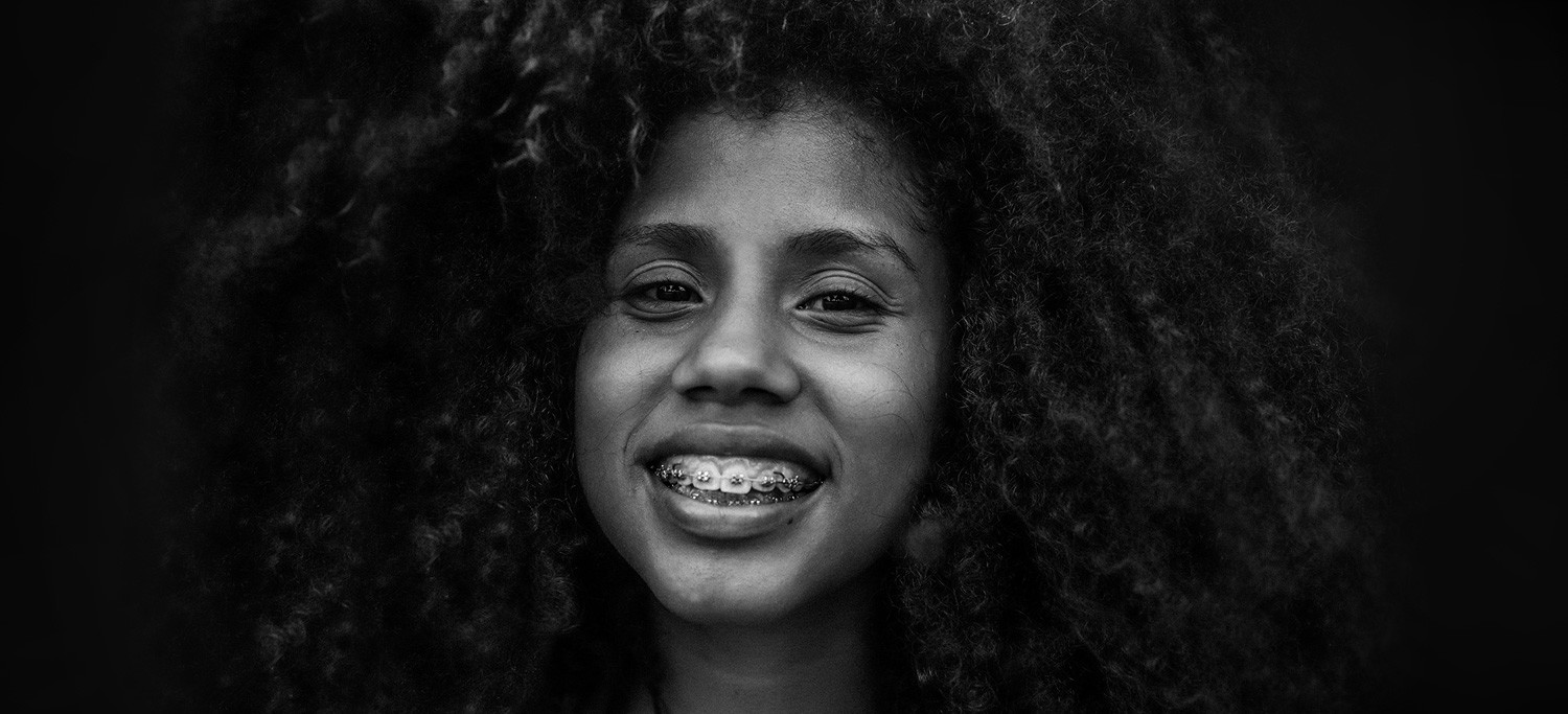 Black and White Photo of a Woman with Braces Smiling