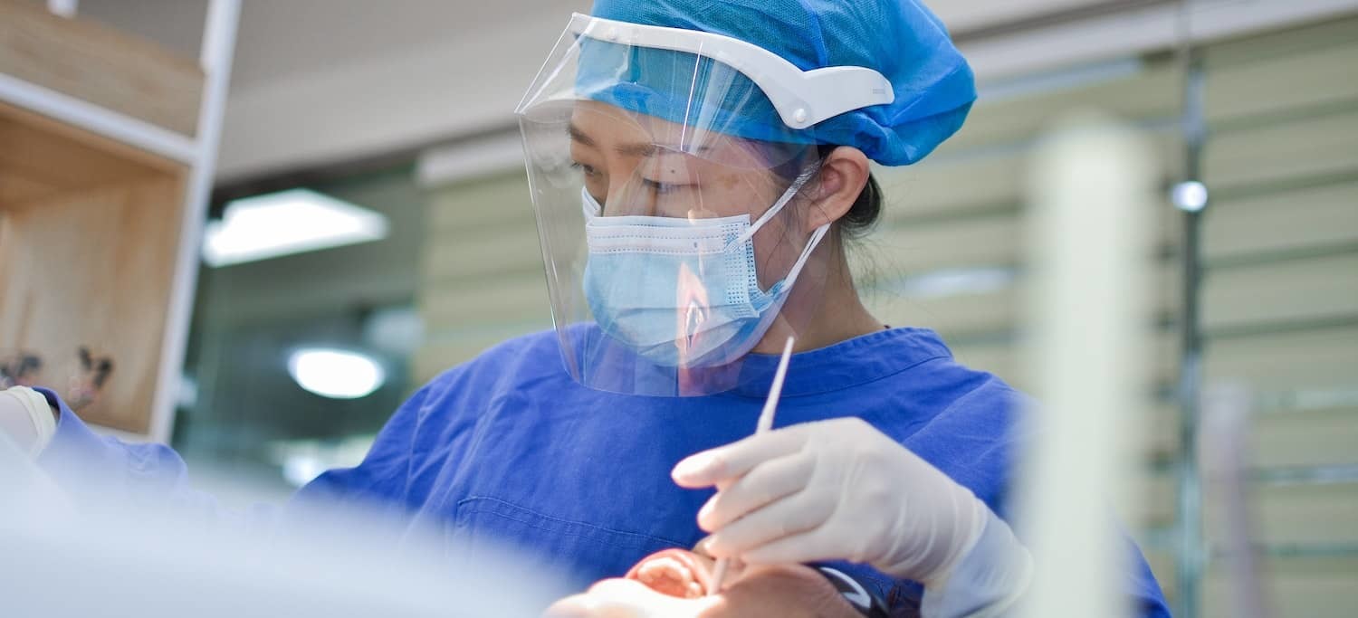 Dentist Performing an Excisional Oral Biopsy in a Patient's Mouth