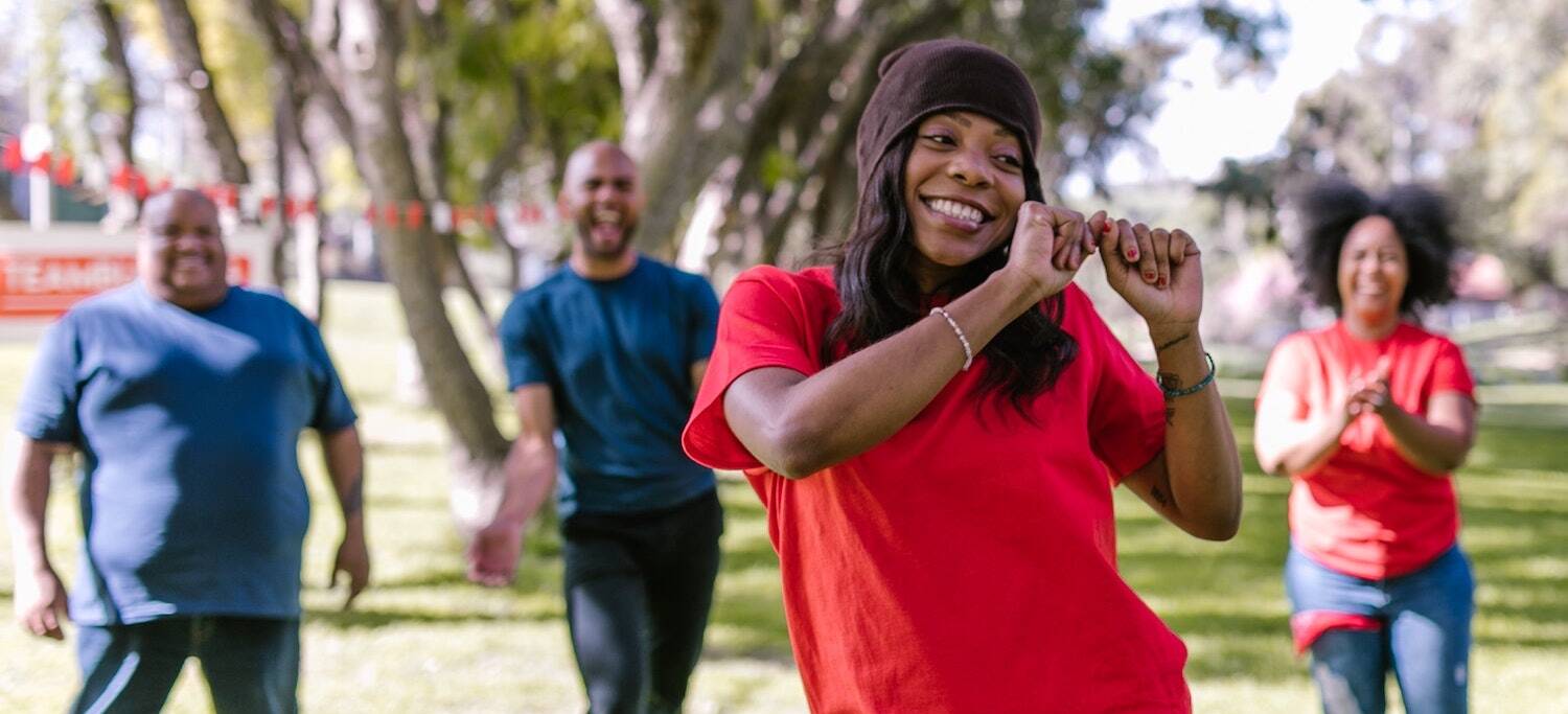 Group of four people dancing outside