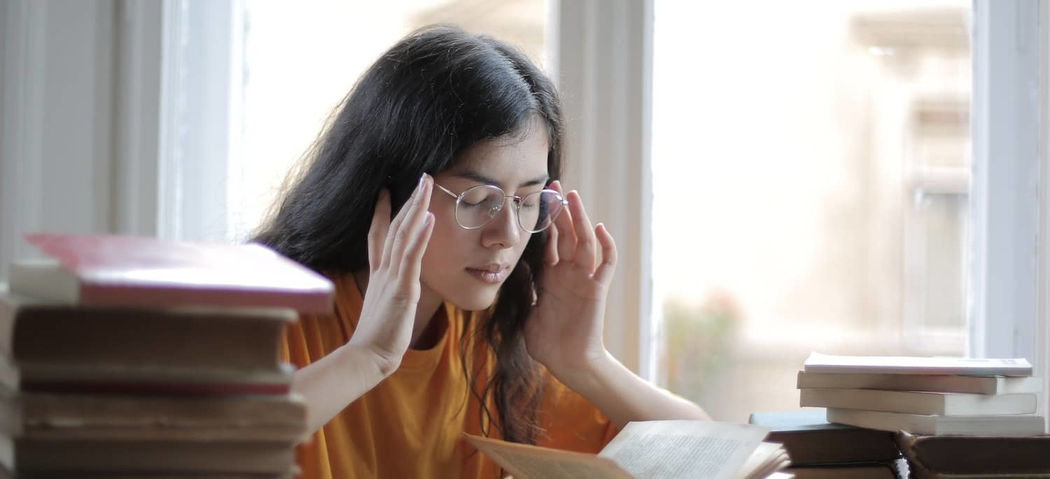 Woman Holding Jaw in Visible Pain - Preventive and Avoidance-Based Temporomandibular Treatments