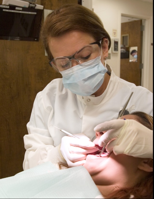 Dr. Suarez at the USC Dental School of Dentistry performs a clinical examination on a patient.