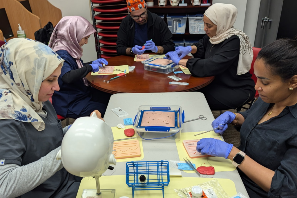 OPR bootcamp students at table practicing skills