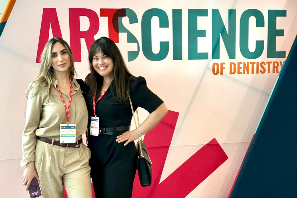 COH students smiling at a conference.
